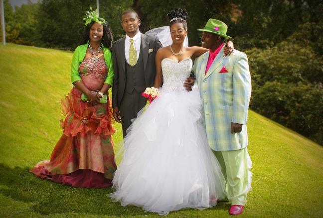 Wedding, caption, (Proud Archbishop and the Prophetess with their new son-in-law nd daughter)